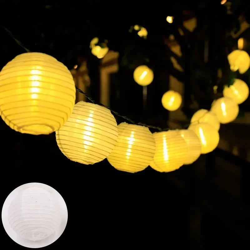 String of yellow paper lantern lights against a dark background