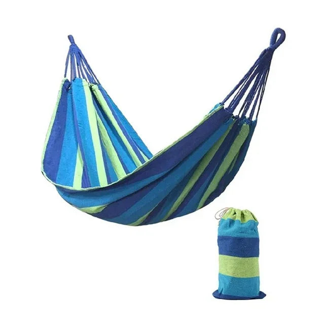 Blue and green striped hammock with matching carrying bag on a white background