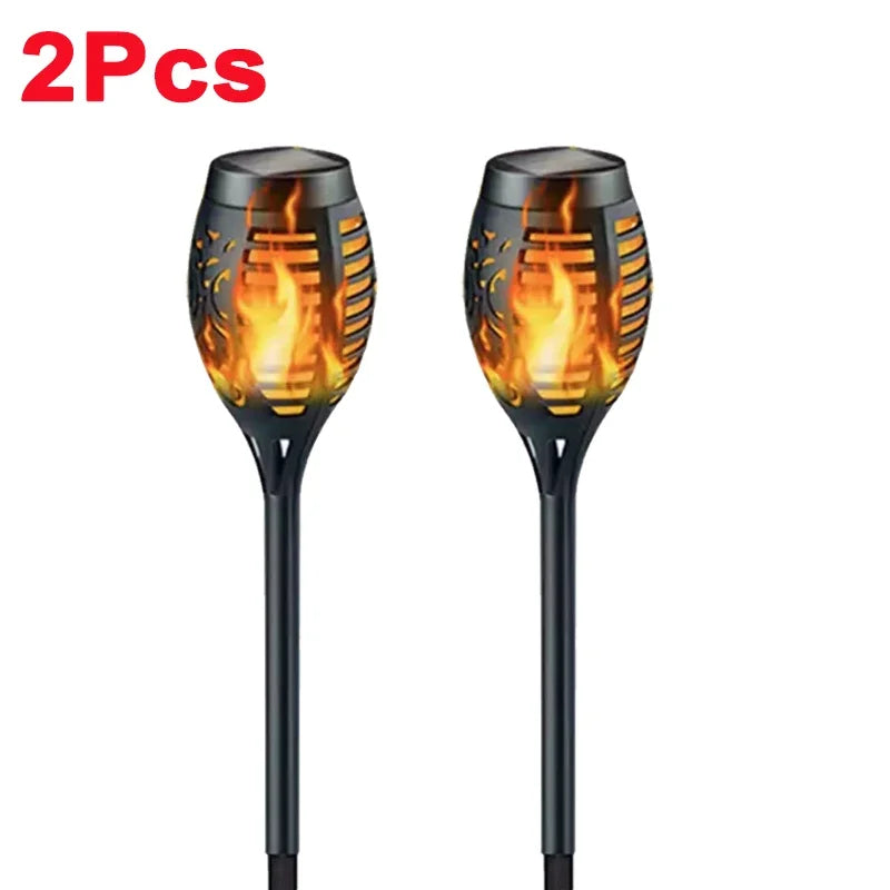 Two solar garden lights with flame design on a white background