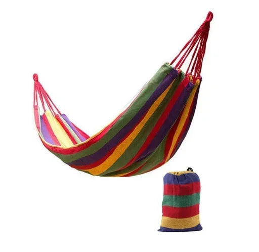 Colorful striped hammock with matching carrying bag on a white background