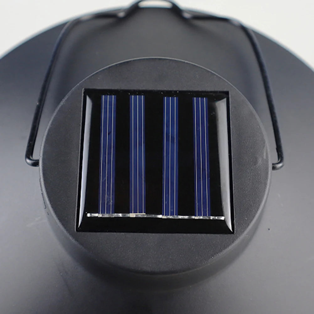 Close-up of a solar panel on a black circular device with a white background