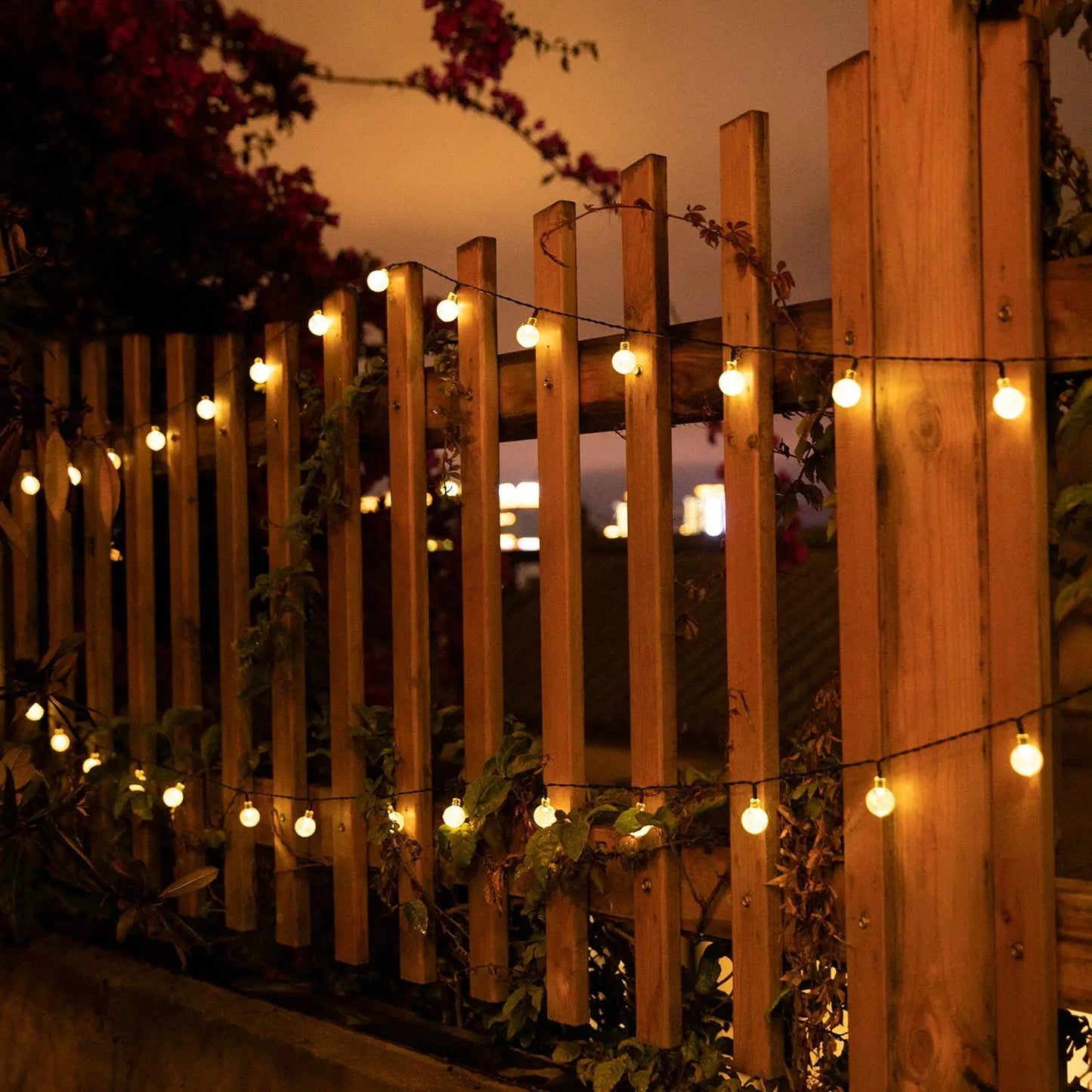 String lights on a wooden fence at night