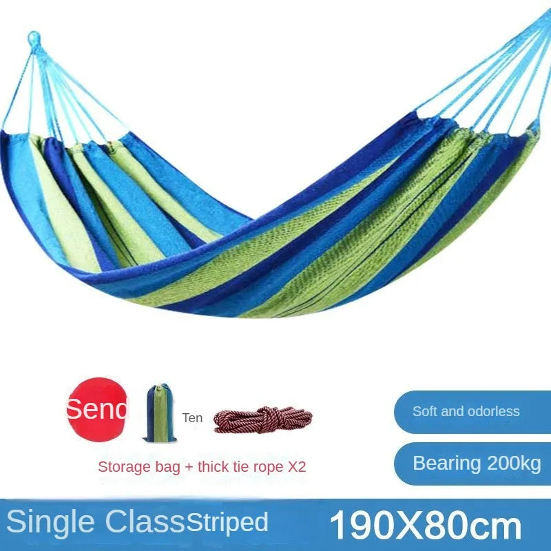 Blue and green striped hammock with storage bag and tie rope on a white background
