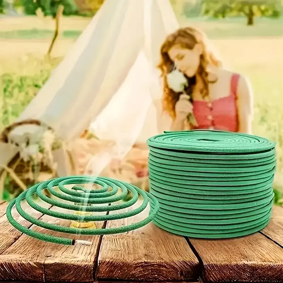 Green incense coils on a wooden surface with a blurred background of a woman and tent.