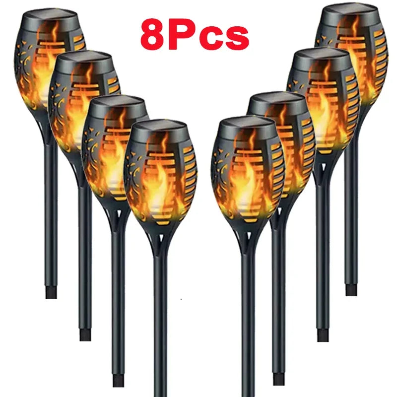 Eight solar garden lights with flame design on a white background, labeled '8Pcs'.