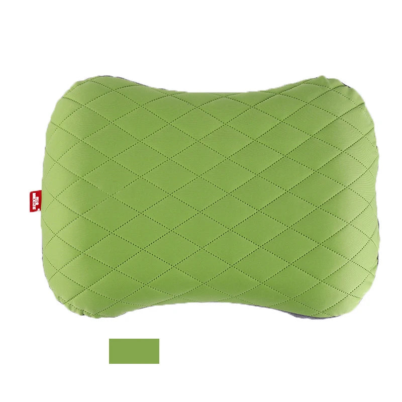 Green quilted pillow on a white background