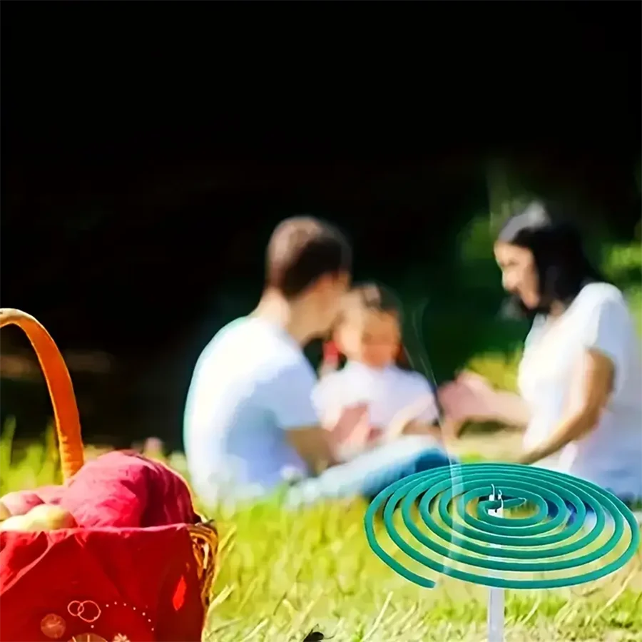 Family having a picnic with a green and blue circular product on the grass.