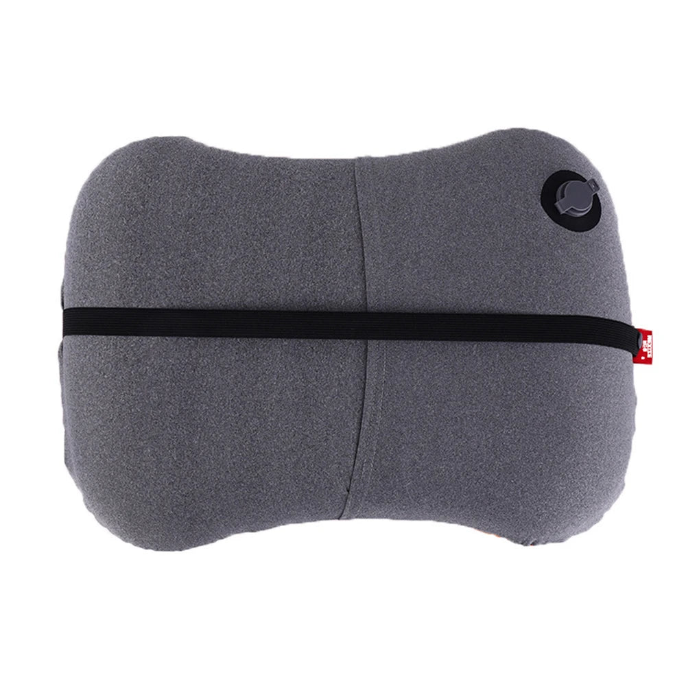 Gray travel pillow with black strap and red tag on a white background