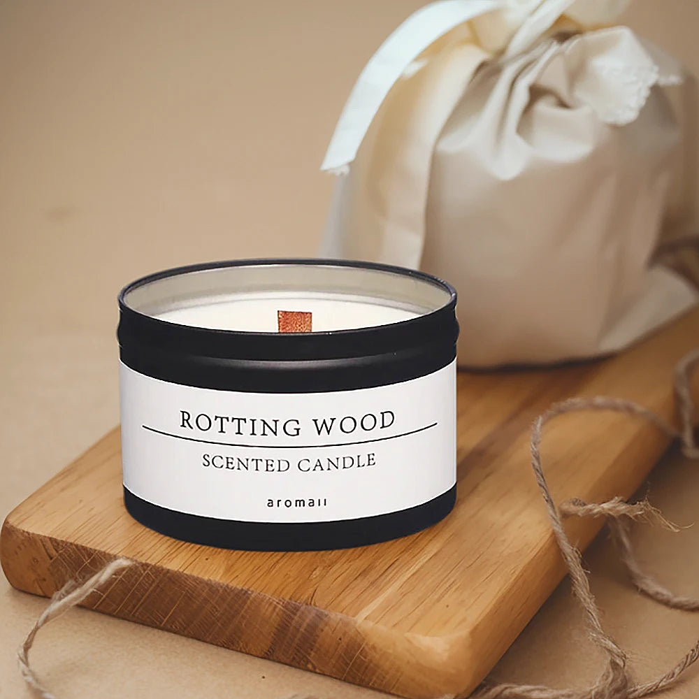 Scented candle labeled 'Rotting Wood' on a wooden board with a beige background