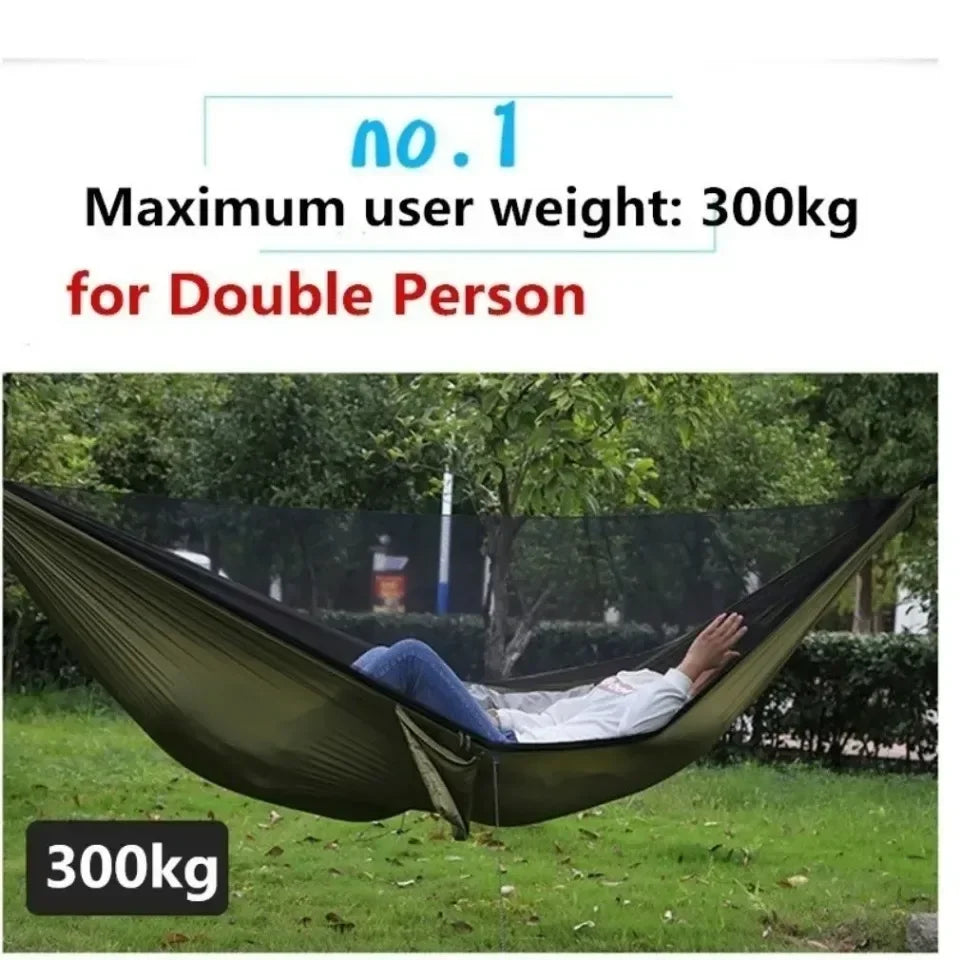 Person lying in a green hammock with text indicating maximum weight capacity on a grassy area.