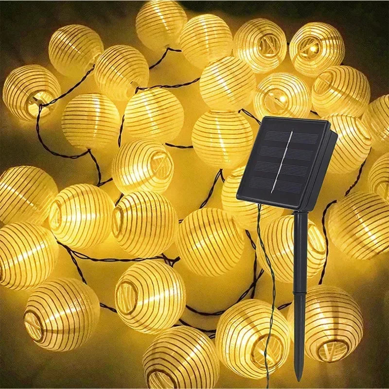 Solar-powered string lights with lantern-style bulbs on a dark background