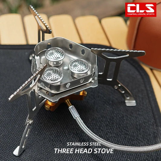 Three-head camping stove with CLS branding on a blurred background