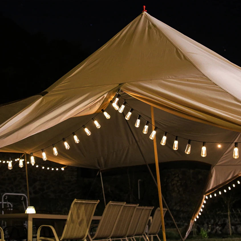 Beige tent with string lights at night