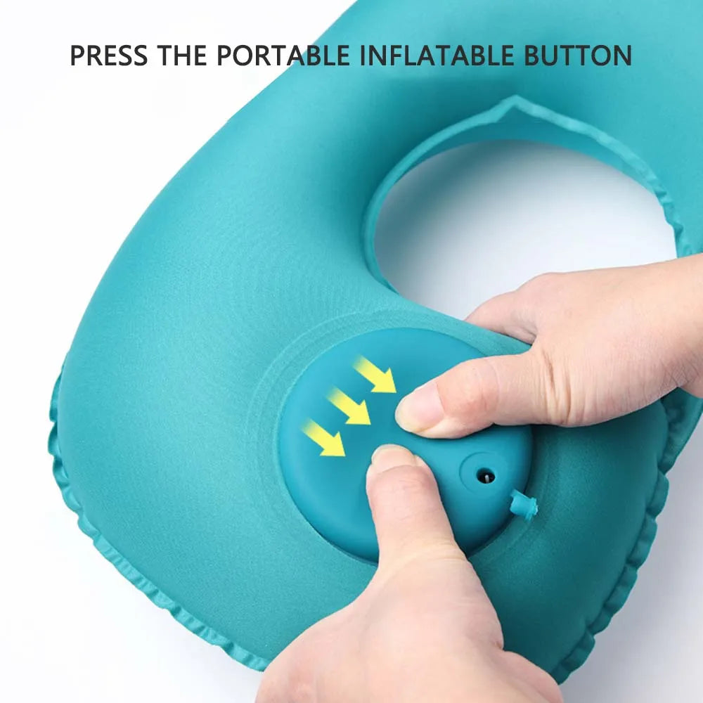 Teal inflatable pillow with a hand pressing a button on a white background