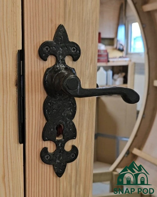 SnapPod’s new 6ft curved round glamping pod door featuring elegant black ironmongery lever handle and secure 5-lever sash lock on sustainably sourced Douglas Fir timber with two-part epoxy marine-grade sealant