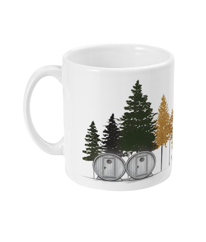 White mug with forest design featuring trees and cabins on a white background