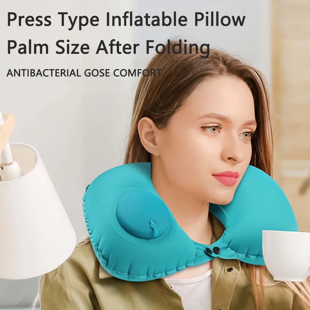 Woman wearing a blue inflatable neck pillow while holding a cup.