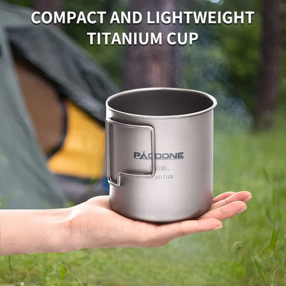 Compact and lightweight titanium cup held in a hand with camping background