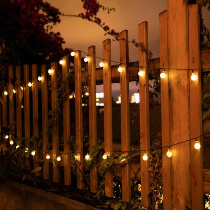 String lights on a wooden fence at night