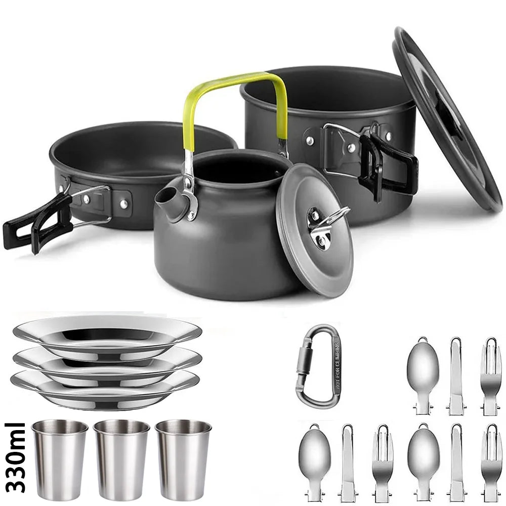 Set of camping cookware including pots, pans, a kettle, and utensils on a white background.