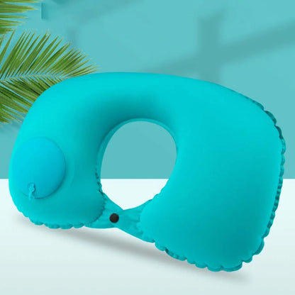 Turquoise inflatable neck pillow on a light blue background with a palm leaf.