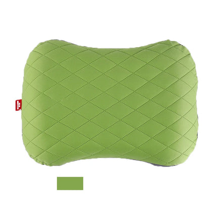 Green quilted pillow on a white background