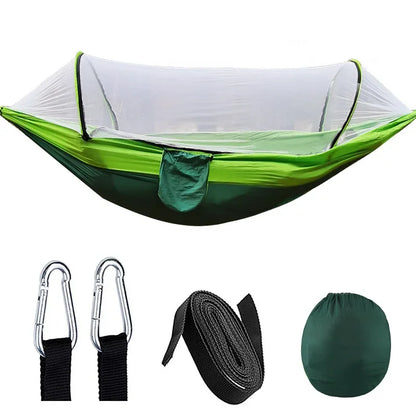 Green camping hammock with accessories on a white background