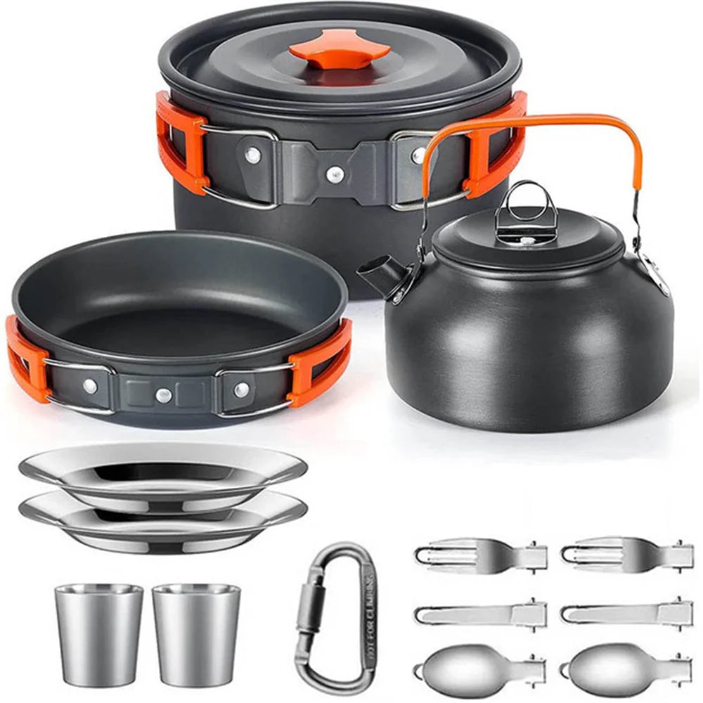 Camping cookware set with pots, pans, kettle, and utensils on a white background