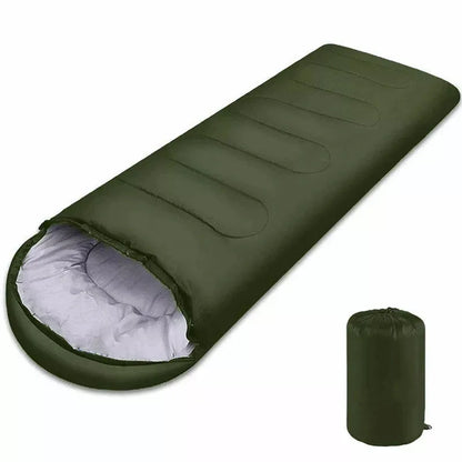 Green sleeping bag with white interior and matching green compression sack on a white background