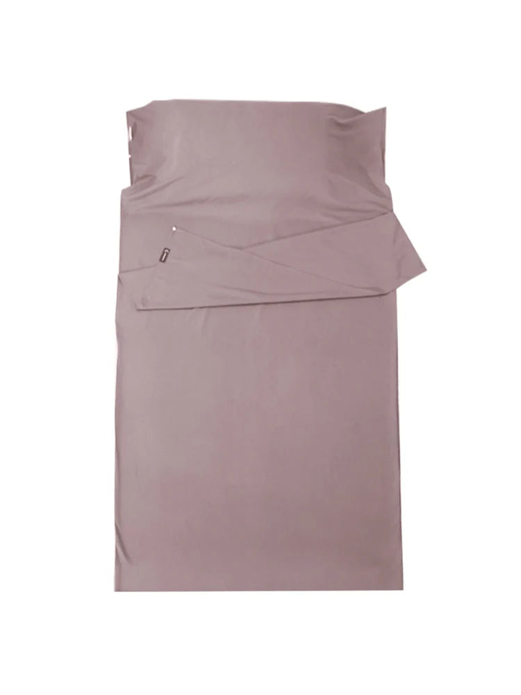 Folded mauve bed sheet set on a white background