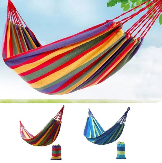 Colorful striped hammock with carrying bags against a clear sky.