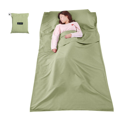 Person lying in a green sleeping bag with a matching pillow on a white background