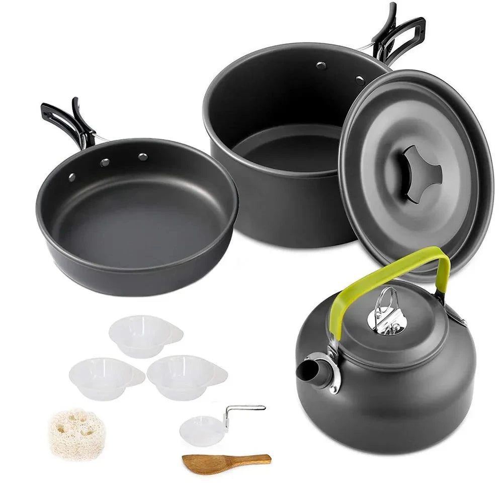 Set of camping cookware including pots, pans, and a kettle on a white background