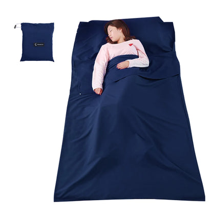 Person sleeping under a blue sleeping bag with a matching pillow on a white background