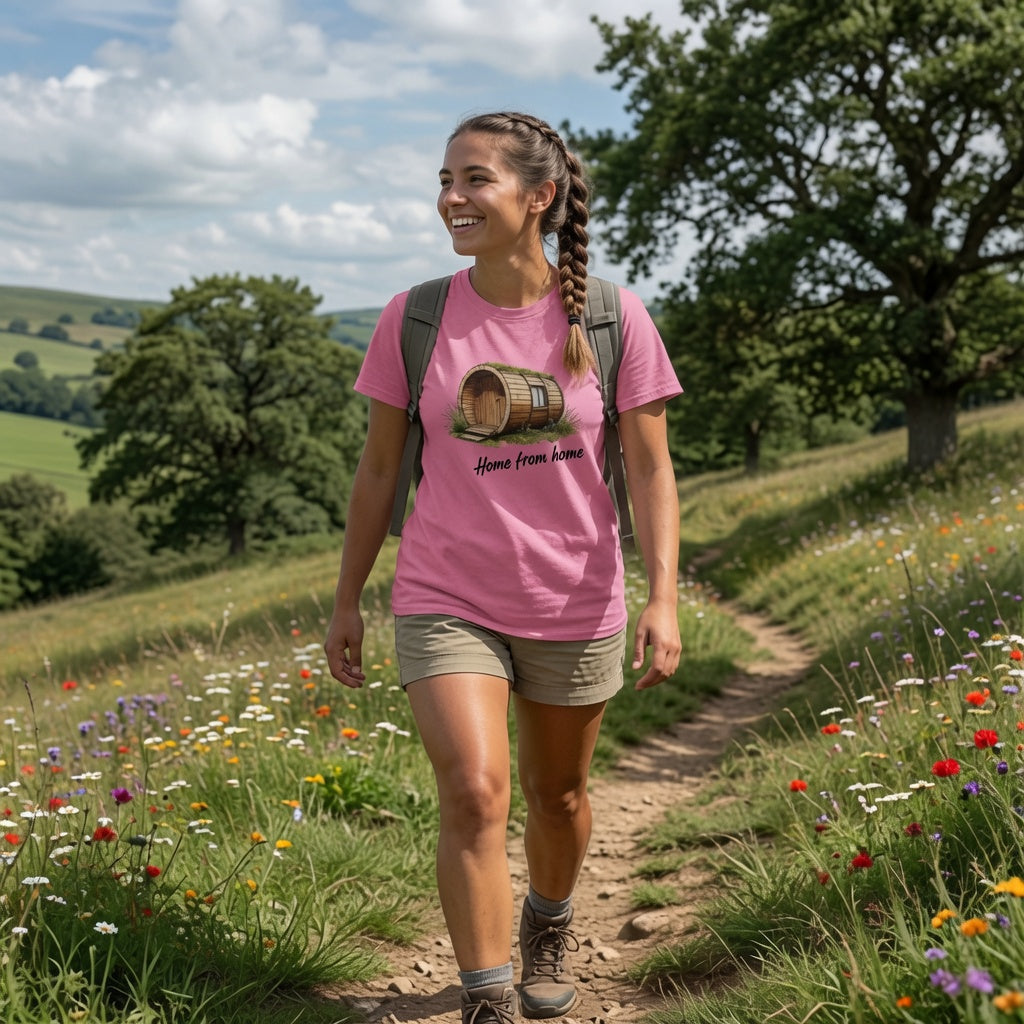 Woman hiking on a trail with a pink t-shirt and backpack in a scenic outdoor setting.