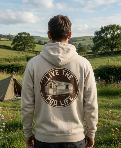 Person wearing a hoodie with 'Live the Pod Life' design in a scenic outdoor setting